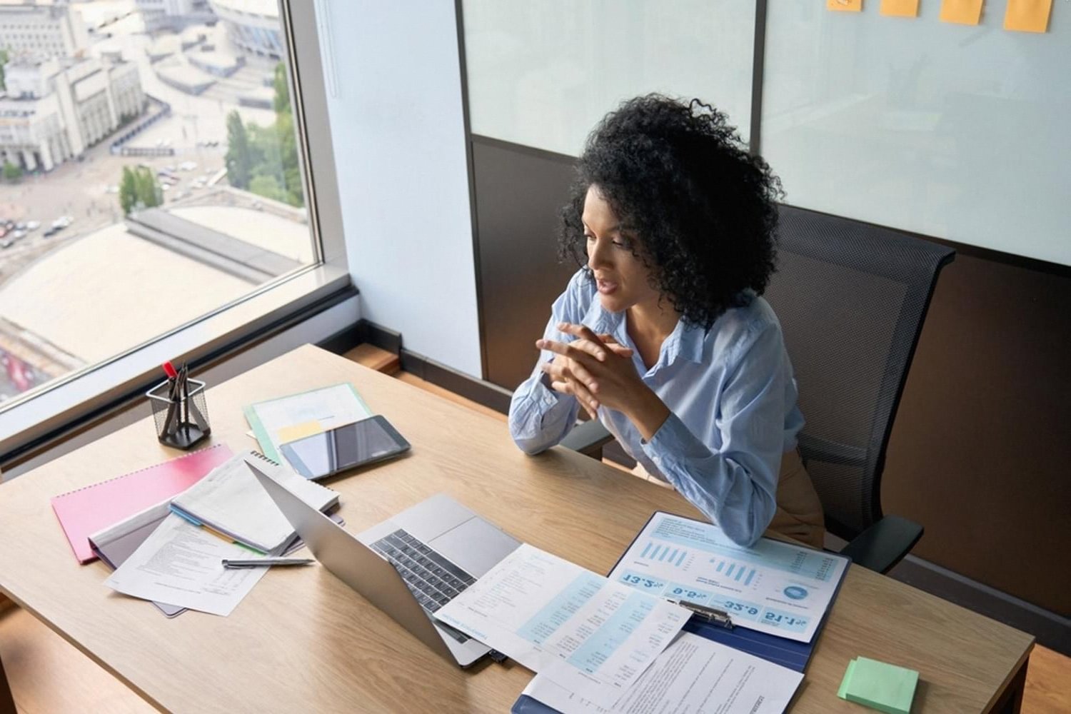 Risk analyst reviewing financial dashboards and reports in a UAE corporate office